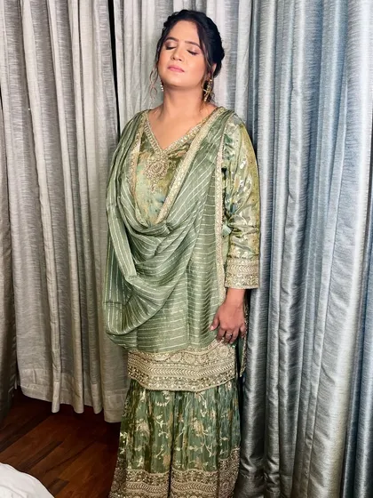 The full look, showcasing the beautiful pastel green outfit and the understated, elegant makeup.