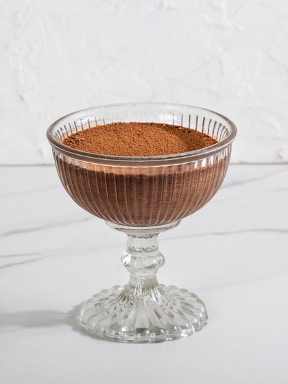 A single serving of my dark chocolate mousse in a vintage-style glass, dusted with cocoa. Simple, elegant, and intensely flavorful.