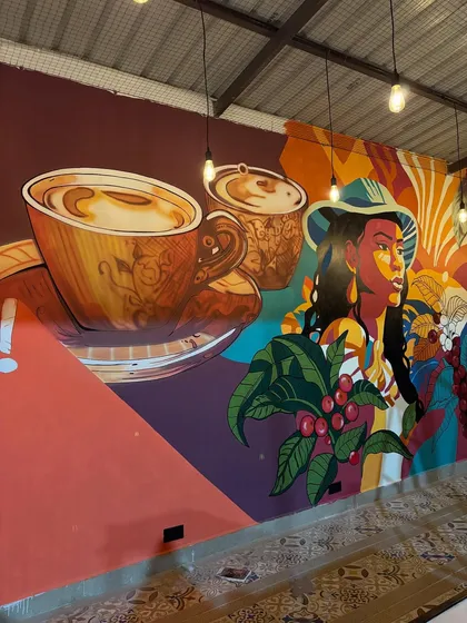 Another view of the coffee mural, showing how the artwork wraps around the corner and creates a continuous visual experience in the cafe.