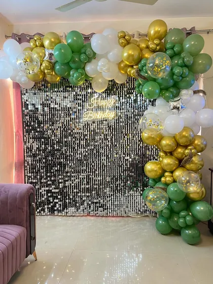 The sequin wall backdrop placed in a living room, showing how it can transform a home space for a party.
