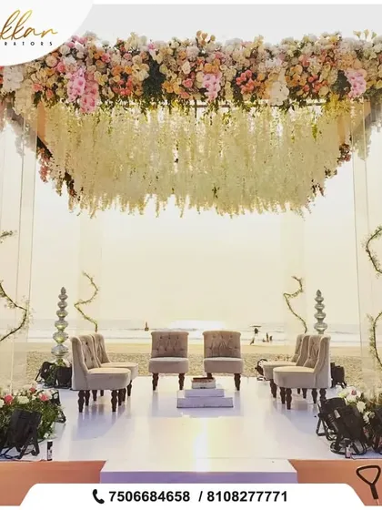 A beautiful beachside mandap setup. The floral canopy against the sunset creates a paradise-like setting for the couple to exchange their vows.