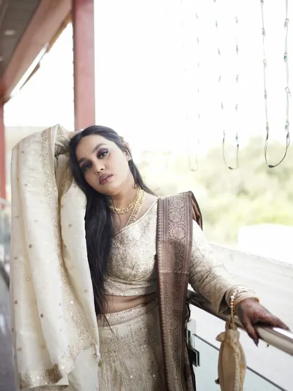 An artistic pose of the sister of the bride, showcasing her flowing dupatta and elegant hairstyle.