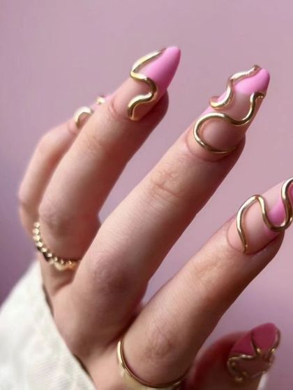A unique and artistic design with a matte pink base and raised, 3D gold wire-like swirls.