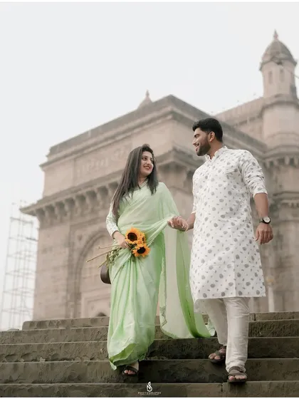 A beautiful shot of the couple walking down the steps, with the Gateway of India perfectly framed.