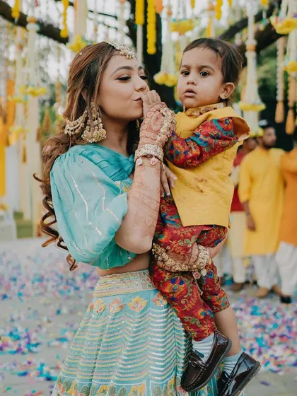 We love being a part of your family's special moments. Here is one of our adorable clients celebrating a Haldi ceremony in his custom-fit printed kurta and bright yellow Bundi jacket, looking festive and feeling comfortable.