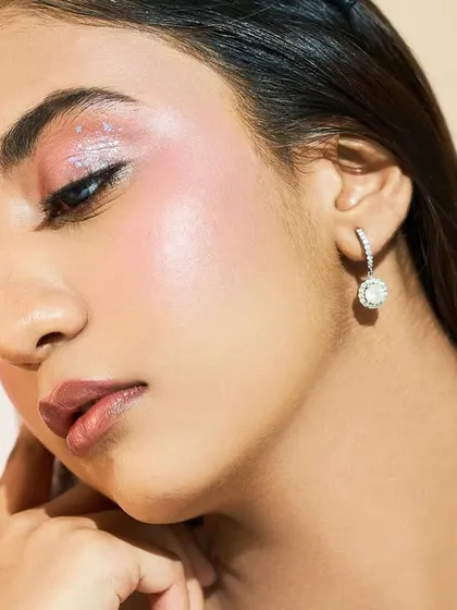 A softer angle of the glittery pink look. The dewy skin provides the perfect canvas for the more playful elements on the eye.