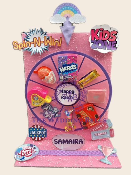 We love making Rakhi fun for the little ones. This personalized "Spin-N-Win" hamper for Samaira is loaded with candies and treats, making it a playful and exciting gift.