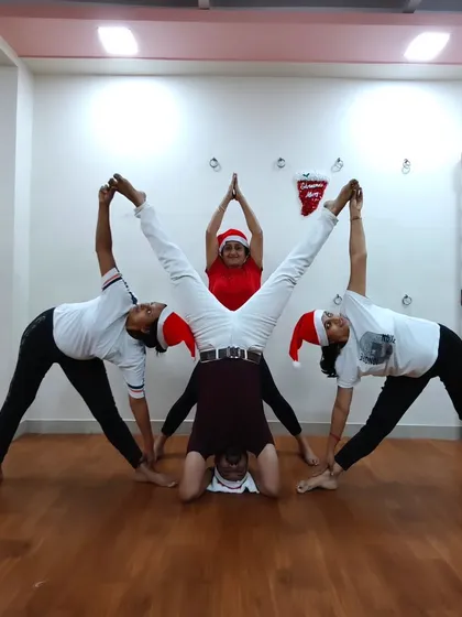 Another fun Christmas celebration pose. These moments of creativity and teamwork build a strong bond within our yoga family.