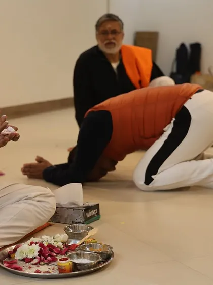 A student prostrates in front of the altar, showing humility and readiness to receive the teachings.
