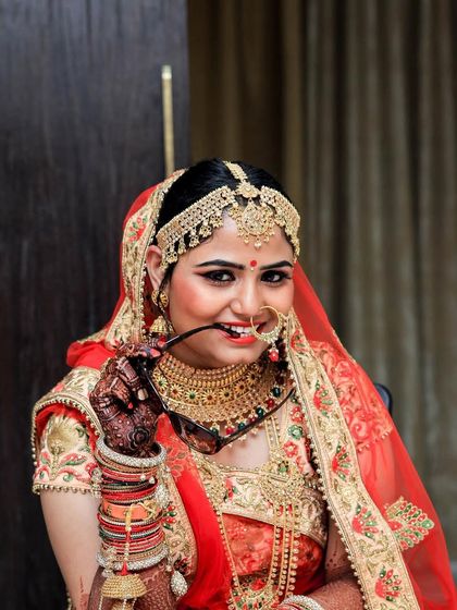 A playful and confident bride, posing with her sunglasses. We love it when brides show their personality in their portraits.