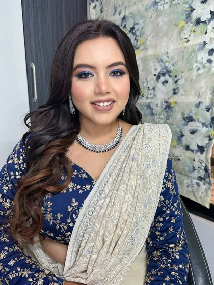 This angle shows how the dramatic eye makeup works with her soft, wavy hair and elegant jewelry. It's a complete look that is perfect for any evening celebration.