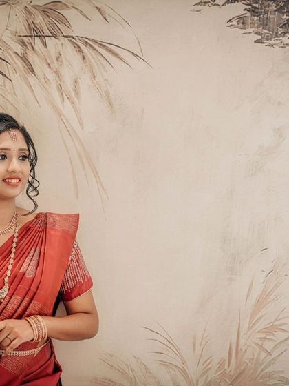 An elegant bridal portrait with the bride standing against a beautifully painted wall, creating an artistic feel.