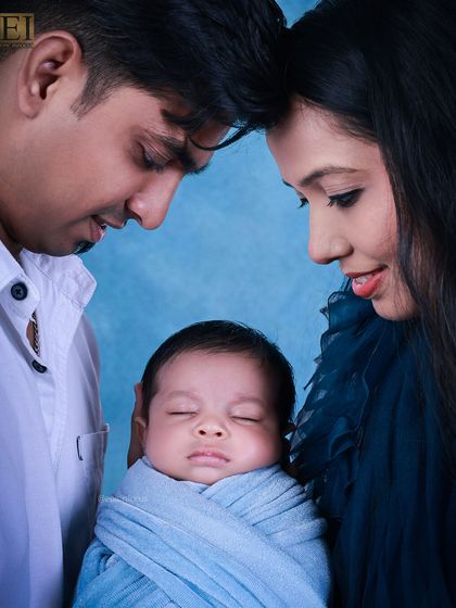 An intimate close-up of parents and their newborn, forehead to forehead. We aim to capture the quiet, powerful emotions of early parenthood in our family sessions.