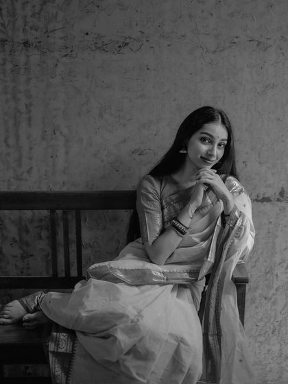 A sweet, seated pose in black and white, conveying innocence and charm.