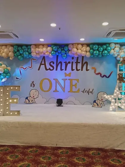 A stage decoration for Ashrith's "ONE-derful" first birthday. While I specialize in newborn events, I also create fun setups for first birthdays, like this one with marquee lights and cute illustrations.