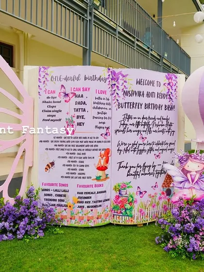 A personalized storybook welcome sign for Nishvika's butterfly birthday, complete with a giant butterfly wing prop.