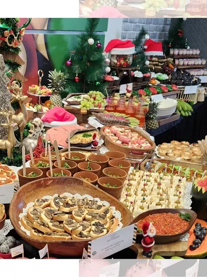 A merry and bright Christmas grazing table. We went all out with festive decorations, including mini Christmas trees and Santa hats, to accompany a lavish spread of savory bites, cheeses, and desserts.