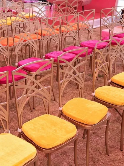 Even the guest seating gets a splash of color, with chair cushions in shades of pink, orange, and yellow to match the 'Spectrum of Love' theme.