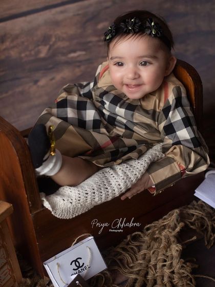 A close-up portrait from the designer-themed session, capturing a happy and content smile.