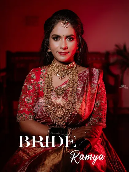 A stunning portrait of a South Indian bride in a red and gold Kanjeevaram saree, showcasing her regal look.