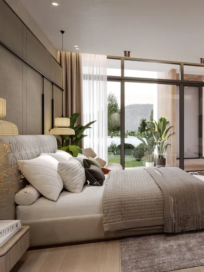 This angle captures the view from the bed to the garden, with large glass doors blurring the line between indoors and outdoors.