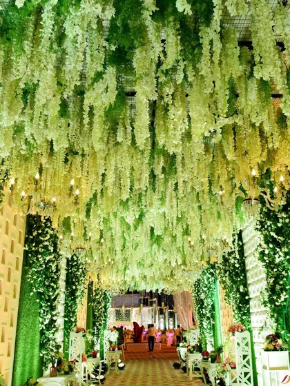 A closer look at the hanging wisteria ceiling. The gradient of green to white adds depth and a natural feel to this stunning floral installation.