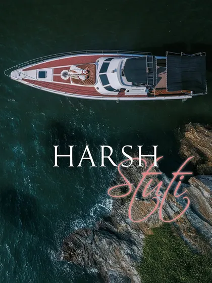 An aerial drone shot captures a couple relaxing on the bow of a yacht in the serene blue waters of Goa. This highlights my destination photography services, creating luxurious and cinematic memories wherever your story takes you.