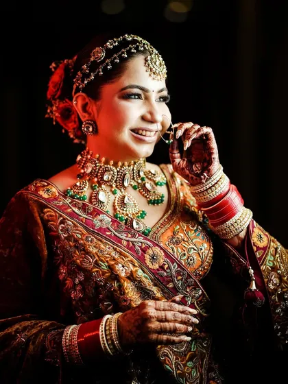 A classic bridal portrait, capturing the bride's happy expression and beautiful nath.