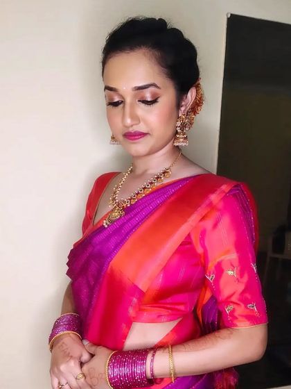 Aishwarya looking gorgeous for her friend's wedding. We chose a soft glam look with a pink lip to match her stunning pink and orange saree.