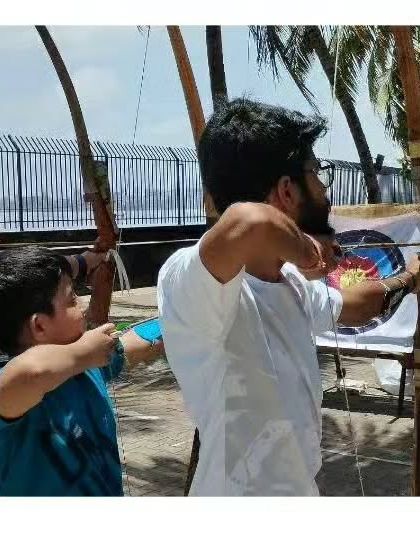 I believe in hands-on coaching. Here, I'm helping a young student adjust his form to ensure he develops good habits right from the start.