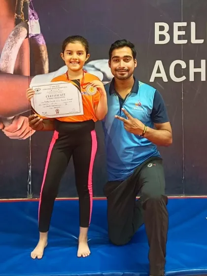 A big smile from this gymnast who earned a medal and certificate for her performance.