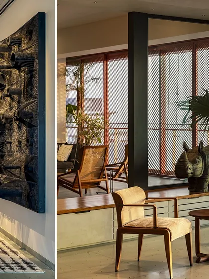 In the Sampurna Residence, art and architecture are integrated. A large sculptural piece hangs in the corridor, while the living area beyond features perforated screens and views to an indoor courtyard.