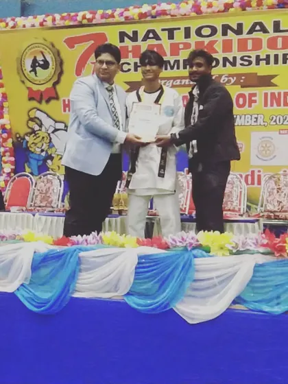 My student receiving his certificate and medal for Hapkido. I am proud to have coached him to this victory.