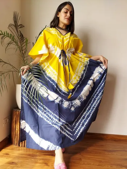A vibrant yellow and indigo tie-dye kaftan. The bold color combination and artistic pattern make this a true statement piece for your casual wardrobe.