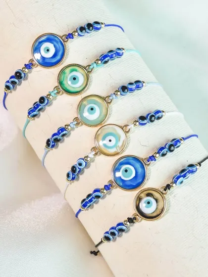 More of my evil eye rakhi collection, featuring classic round designs with beaded details.