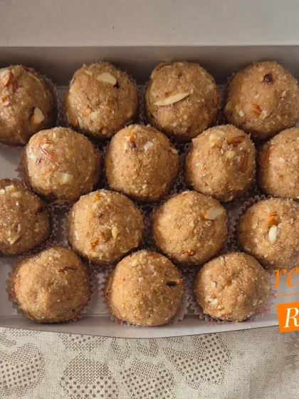 A close-up of the Choorma Laddoos, highlighting the crunchy almond pieces mixed into the grainy base.