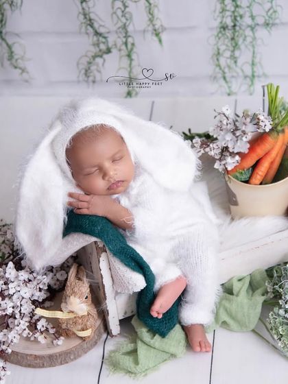 Our little bunny is ready for his carrots! This is a wider shot of the theme, showing the full setup with a crate of carrots and other rustic, garden-inspired props.