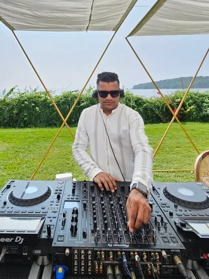 Mixing tracks at the Goa brunch party. I always dress to match the occasion, whether it's a casual beach shirt or a formal suit for a reception.