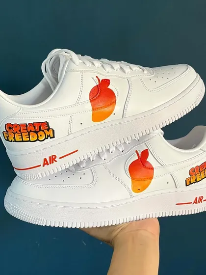 A simple and clean design for these custom Nike AF1s, featuring a mango and the words "Create Freedom."