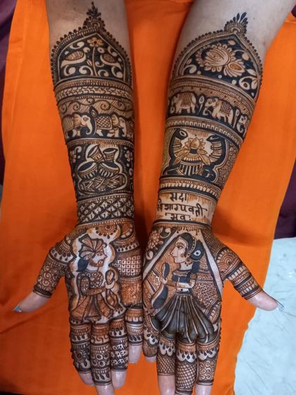 A classic bridal design with a couple portrait on the palms, surrounded by auspicious symbols like the kalash and elephants.