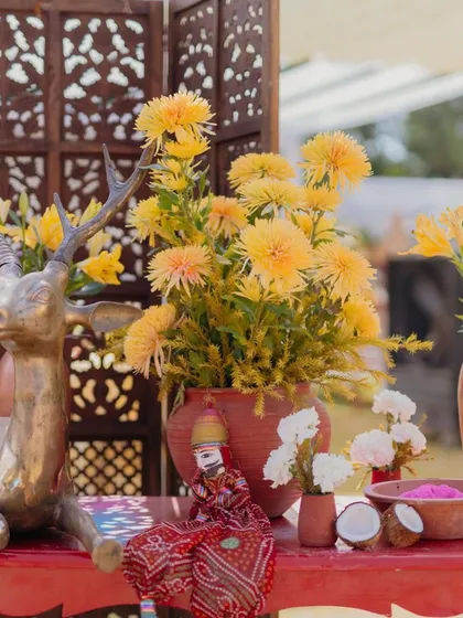 A cute detail from our 'Haldi Holi' event, featuring a Rajasthani puppet sitting amongst the floral arrangements.