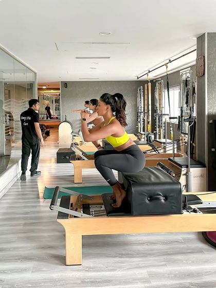 Back to the classics. This deep squat on the Reformer box challenges the glutes and quads while demanding core engagement for stability.