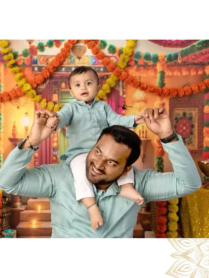 A joyful father gives his son a shoulder ride amidst the festive Diwali decorations. This photo is full of laughter and love.
