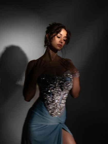 A softer moment from the same ELLE India shoot. The lighting highlights the shimmering details on the corset and the dewy finish I created on her skin.