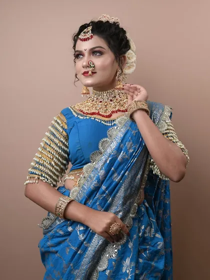 A beautiful Maharashtrian look in a blue saree created by a student for her exam. The pearl-studded blouse is a unique touch.