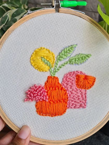 A beautiful piece of abstract floral wall art created with punch needle. The combination of different stitches and textures makes it a unique decor item.