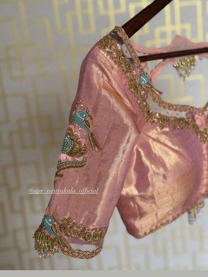 A side view showing the sheer panel on the shoulder and the embroidered sleeve.
