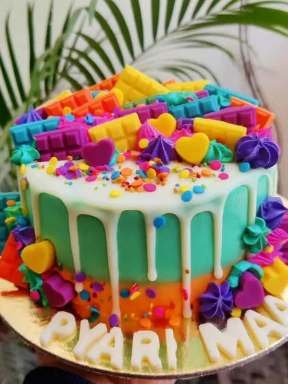 This might be one of my favorite designs ever, I call it the Candyland cake! It’s a burst of color and joy, loaded with rainbow sprinkles and colorful chocolate bars. It proves that sometimes, more is more.