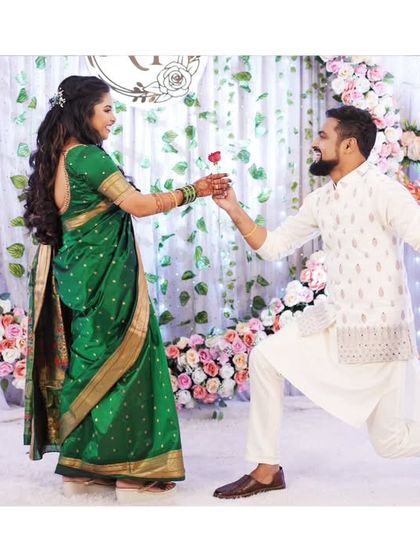 A romantic gesture on the dance floor, with the groom proposing to his bride with a rose.