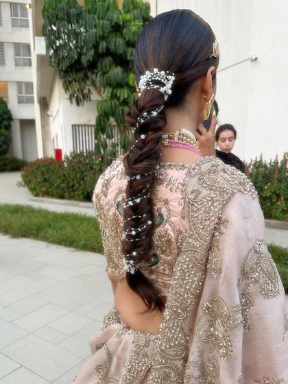 This fishtail braid is given a touch of magic with delicate pearl strands woven through it. It's a soft and romantic look, perfect for an engagement or reception.